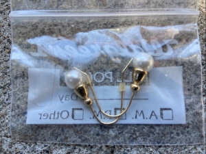 earrings in pill bags